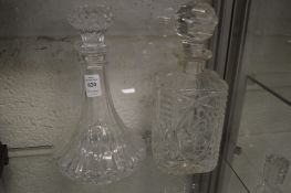 Two glass decanters.