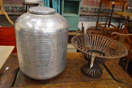 An aluminium storage container or laundry basket together with a wrought iron stand.