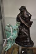 A patinated bronze erotic figure and another similar.
