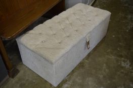 A modern upholstered ottoman.