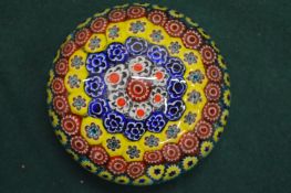 A large glass Millefiori paperweight.