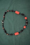 Decorative cinnabar lacquer and cut glass necklace.