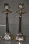 A pair of stylish silver candlesticks.