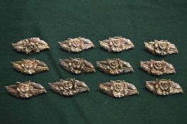 Twelve various metal menu holders.