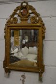 A decorative gilt framed mirror.