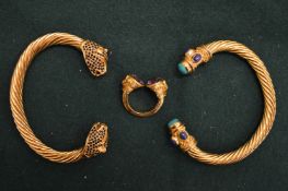 Two torque style gilt metal bangles and a similar ring.