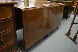 A mahogany drop-leaf dining table with a pair of D ends.