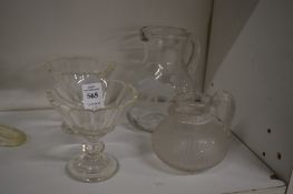 An engraved and cut glass jug depicting an elephant together with other decorative glassware.