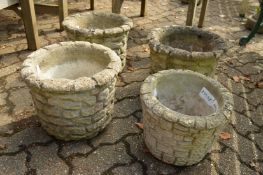 Four reconstituted stone garden planters.