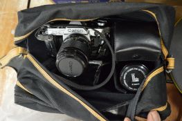 A Canon AE1 camera and numerous accessories.