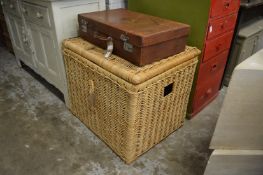 An old leather suitcase and a large wicker trunk.