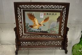 A pierced Chinese table screen with revolving panel painted with an eagle.