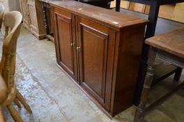An oak two door hanging cupboard.