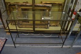 A glass and metal console table.