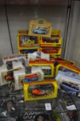 A quantity of boxed model vans and cars.