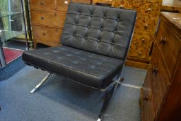 A pair of modern Barcelona chairs.