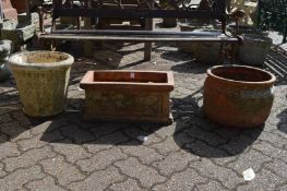 Terracotta plant pot, terracotta trough and reconstituted stone planter.
