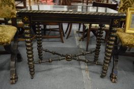 An unusual 19th century ebonised and parcel gilded rectangular fold-over card table on bobbin turned