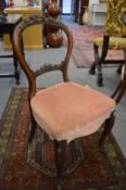 A set of four Victorian walnut balloon back dining chairs.