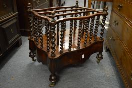 A Victorian walnut three division Canterbury with a drawer to the base.