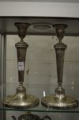 A pair of early 20th century silver candlesticks, possible Indian, each with engraved inscription.