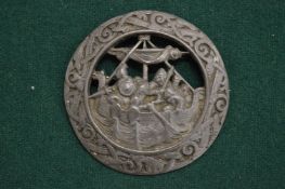 A pewter brooch.