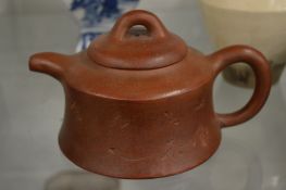 A Chinese Yixing teapot.