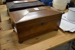 A Victorian mahogany sarcophagus shaped tea caddy.