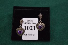 A pair of decorative earrings.