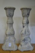 A pair of pottery candle stands.