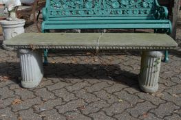 A reconstituted stone garden bench.