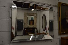 A modern rectangular wall mirror.