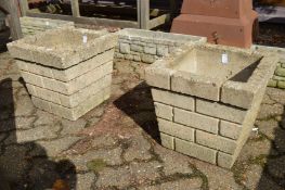 A pair of square shaped reconstituted stone planters.