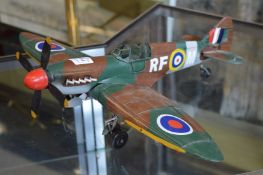 A painted metal model of an aeroplane.