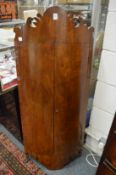 A mahogany bow front hanging corner cupboard.