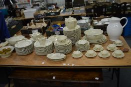 A comprehensive Limoge dinner service, cream ground with gilt decoration.