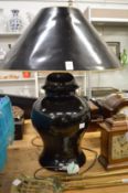 A large black pottery table lamp and shade.