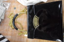 A Cairo black patent leather handbag.