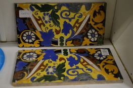 A pair of colourful pottery tiles.