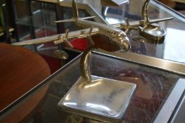 An aluminium model of an aeroplane on stand.