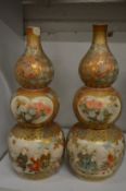 A pair of Japanese satsuma double gourd shaped bottle vases (one with rim chips and repairs to both