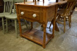 A pine single drawer two-tier table.
