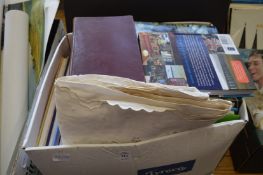 A box of books and a tablecloth.