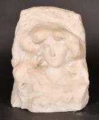 Early 20th Century Continental School, a female face carved into a naturalistic setting, marble,