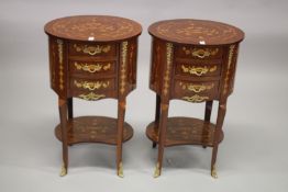A PAIR OF LOUIS XVI STYLE OVAL THREE DRAWER BEDSIDE CUPBOARDS on curving legs with under-tier. 76cms