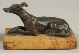 A 19TH CENTURY FRENCH BRONZE WHIPPET on a marble base. 16cms high x 8.5cms wide.