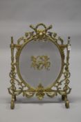 A GOOD FRENCH ORMOLU FIRESCREEN with oval mesh panel, cupids and acanthus scrolls. 90cms high x