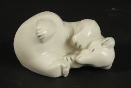 LIMOGES, THARAUD A SLEEPING POTTERY POLAR BEAR. Printed mark and signed. 17cms high x 13cms wide.