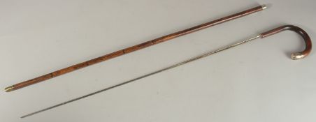 A CANE SWORD STICK with silver mounts. 90cms long.