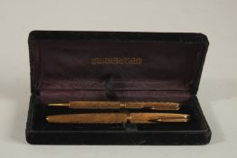 A PAIR OF GILT WATERMAN PENS, fountain pen and pen.